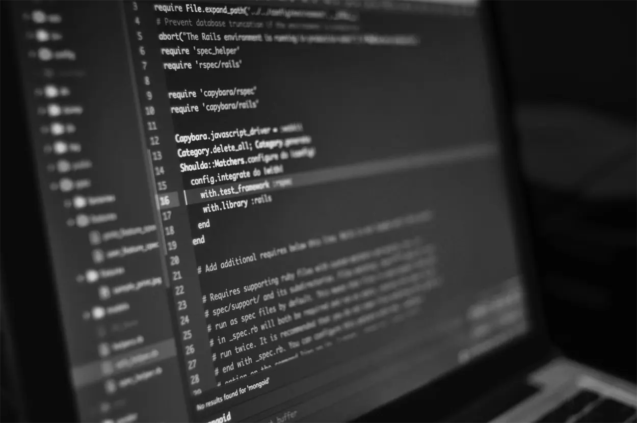 Background image of computer code on a monitor